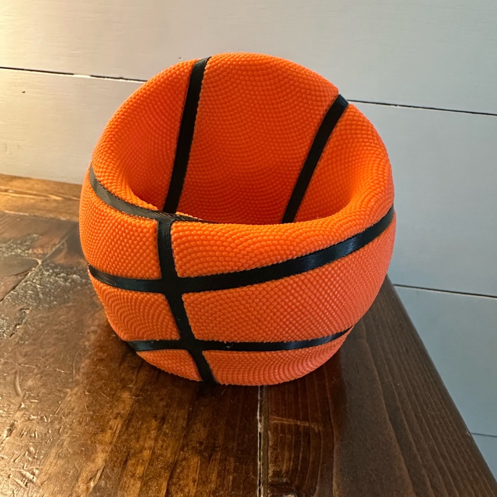 Basketball phone holder with slot for charging cable.